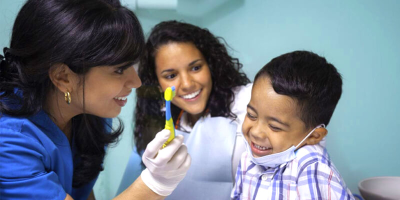 A young boy laughing at a dentist appointment