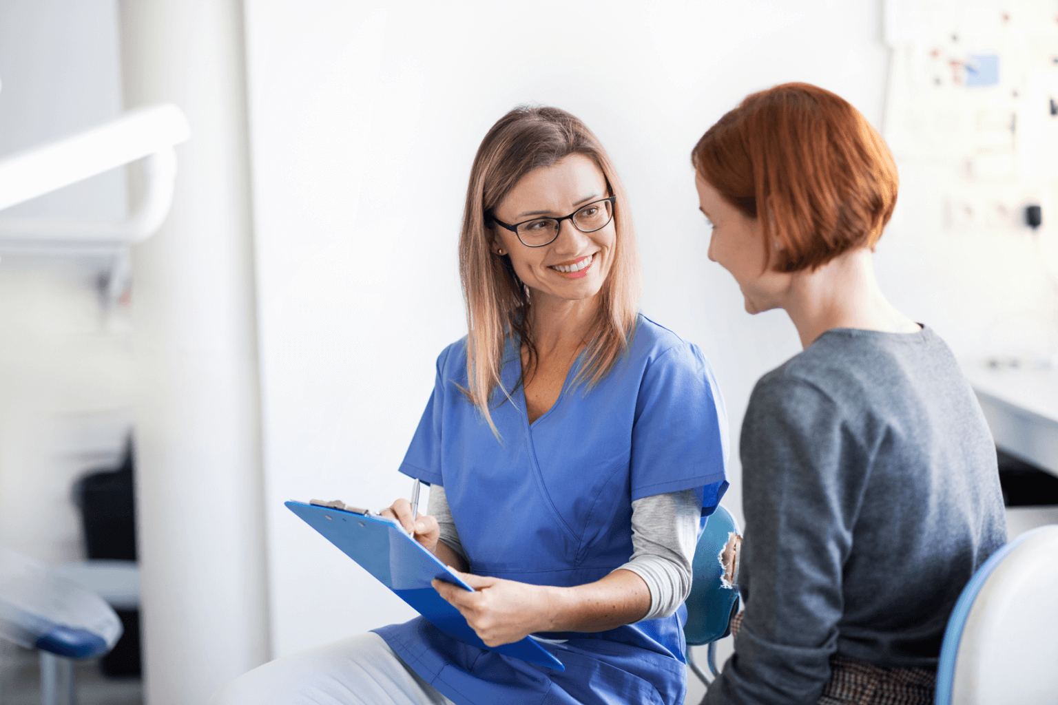 A dentist discussing chart with a patient