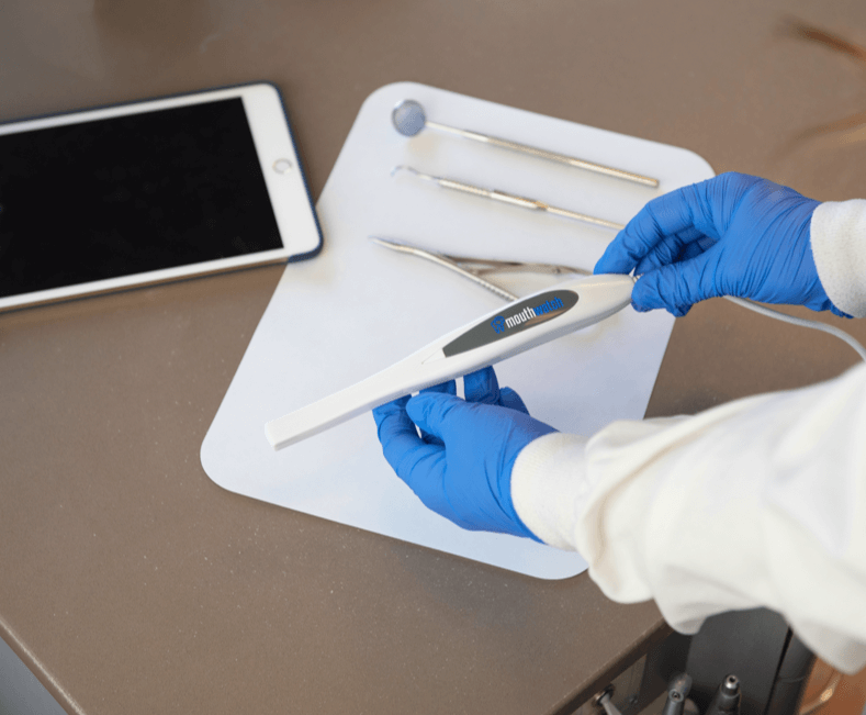 Image of Intraoral device shown with other dental tools